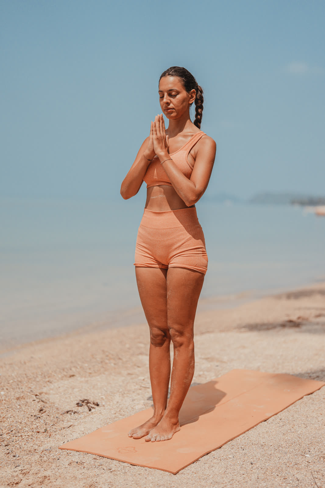 Standing prayer pose at the shoreline